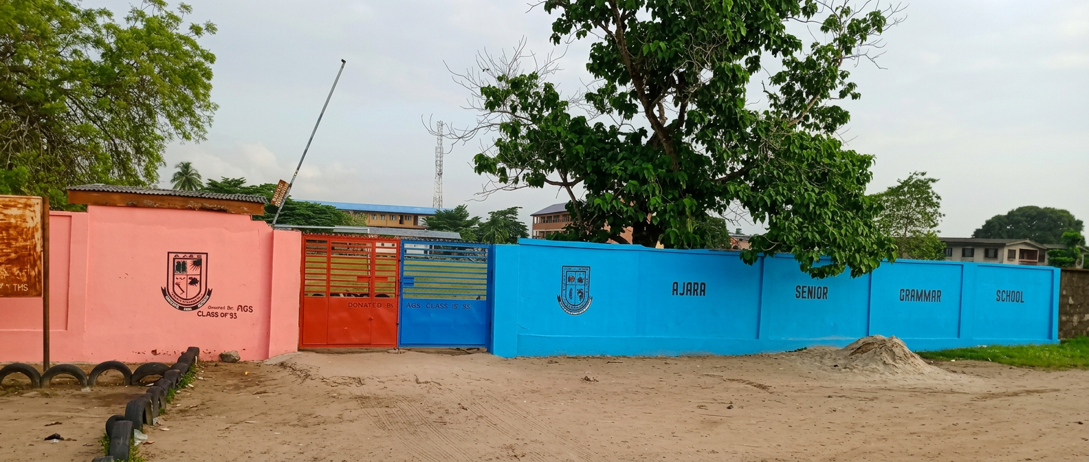 The red and blue gates between the pink junior-school wall and blue senior-school wall